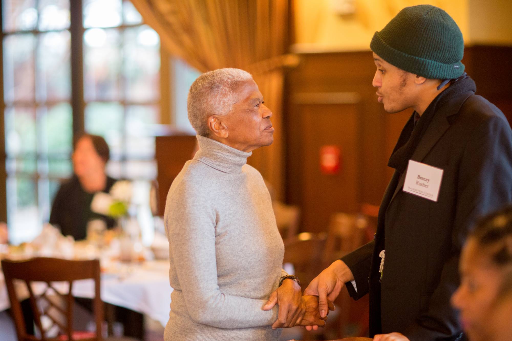 A Cook Leadership Academy fellow shakes the hand of a guest speaker at a pre-event reception.